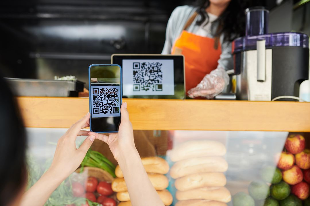 Customer scanning a QR code to order from a takeaway counter